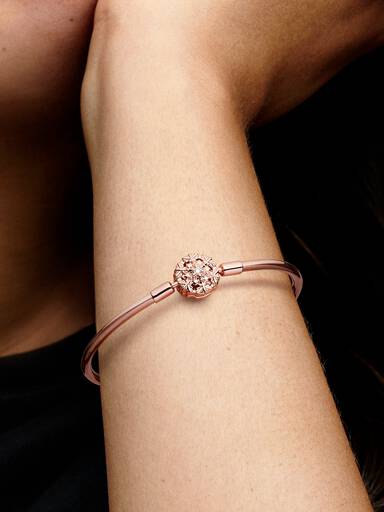 14k Rose gold-plated bangle with snowflake clasp and clear cubic zirconia