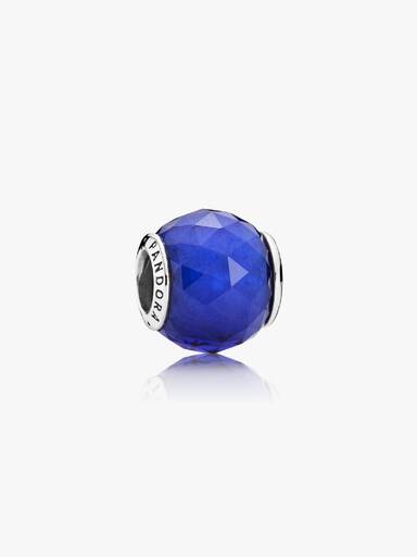 Abstract silver charm with faceted royal blue crystal