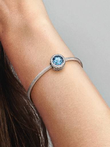 Abstract silver charm with sky blue crystal and clear cubic zirconia