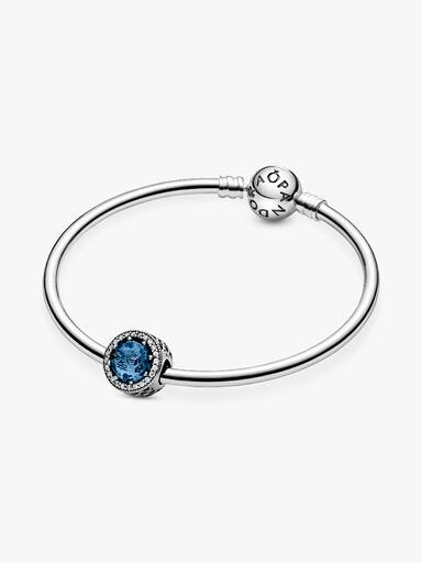 Abstract silver charm with sky blue crystal and clear cubic zirconia