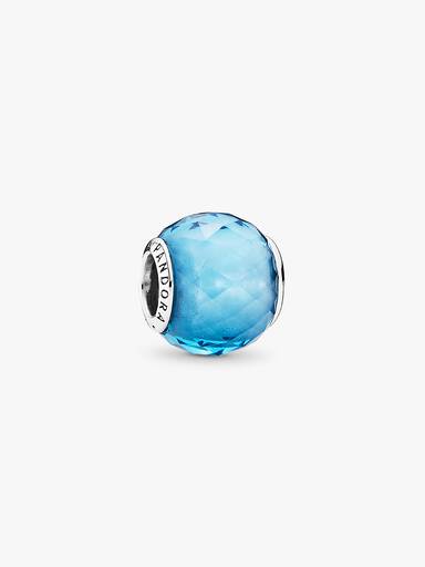 Abstract silver charm with faceted sky blue crystal