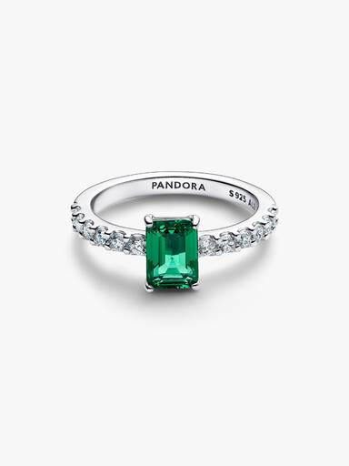 Anel retangular verde cintilante com halo.