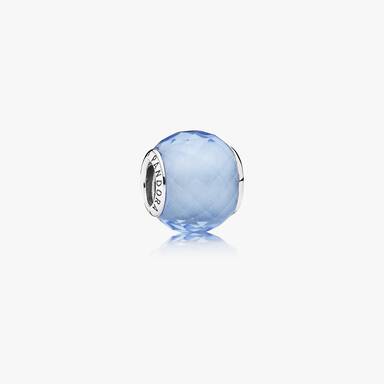 Abstract faceted silver charm with synthetic blue quartz