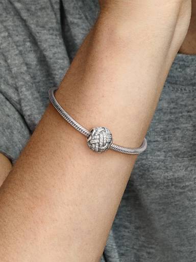 Love knot silver charm with cubic zirconia